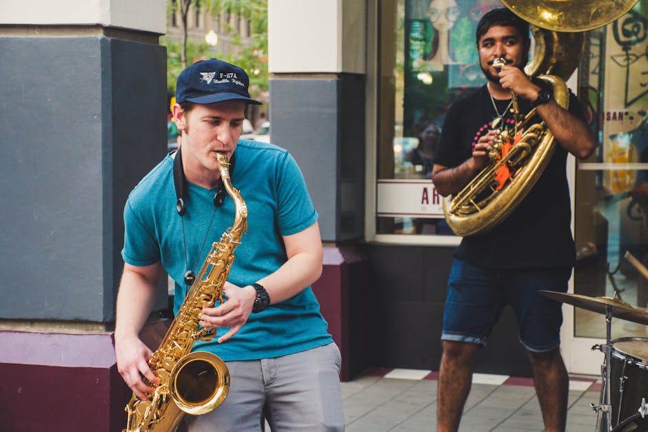 pexels-photo-1365167-1365167 Musicians performing with saxophone and tuba on a city street.