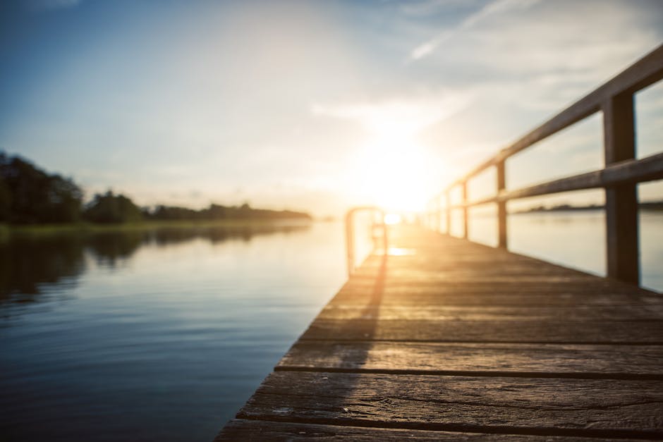 pexels-photo-205002-205002 Peaceful sunset over a calm lake, captured from a wooden boardwalk in Kiel, Germany.