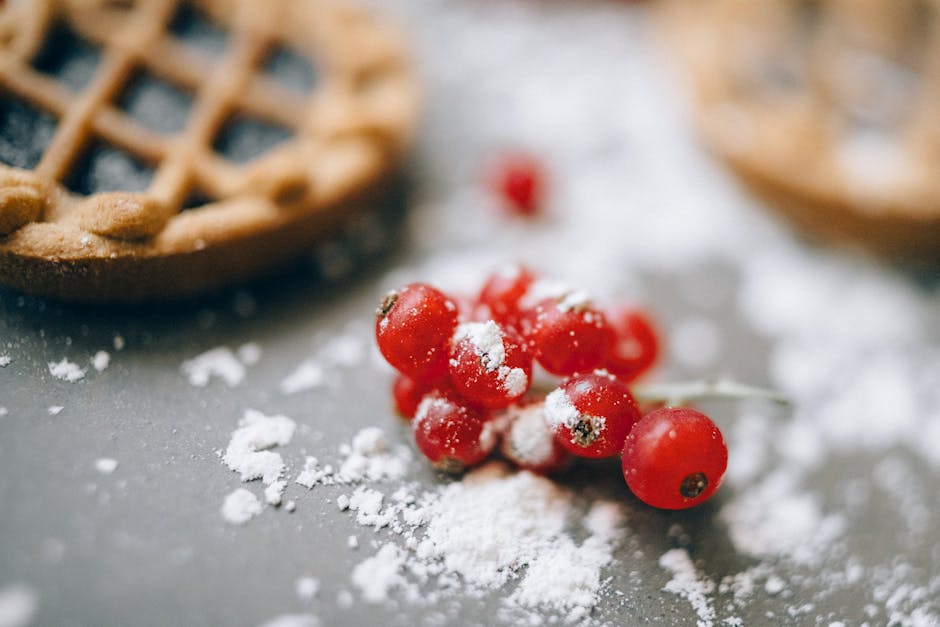 pexels-photo-5426103-5426103 A delectable close-up shot of a lingonberry tart with red berries and sugar dusting.