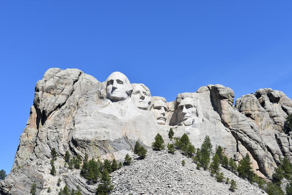 pexels-photo-8619113-8619113 Mount Rushmore featuring presidential sculptures against a clear blue sky.