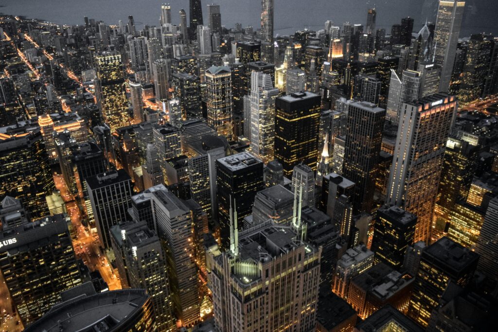 pexels-photo-1036657-1036657 Explore the vibrant skyline of Chicago with its illuminated skyscrapers and bustling urban life captured at dusk.